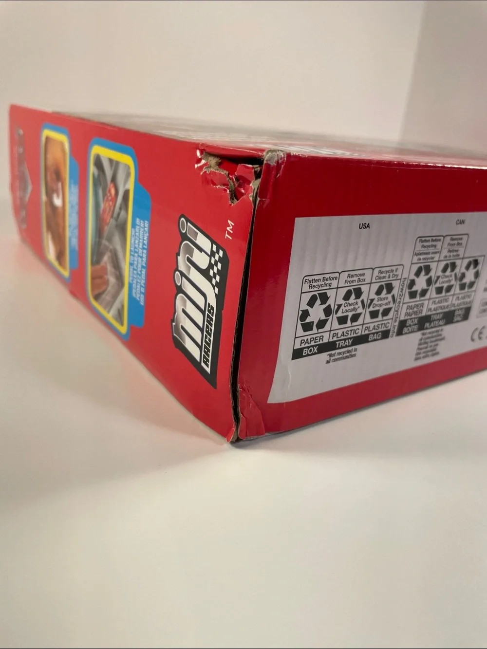 Mini Racers-Cardboard Packaging has dents and a torn spot as shown